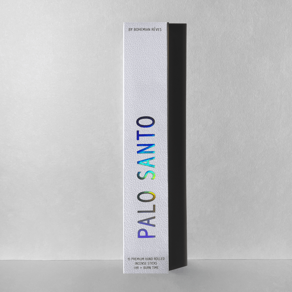Bohemian Rêves Palo Santo incense box standing upright against a soft texture background, showcasing holographic minimalist packaging